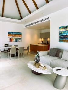 a living room with a couch and a table at Lucky Eight Villa in Ban Phru Champa