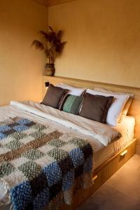 a bedroom with a large bed with a plant on the wall at РІЗНОтрав'я in Solygy