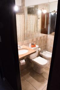 a bathroom with a sink and a toilet and a mirror at Hotel Samka in Salta +17 photos