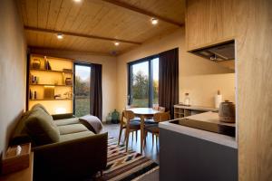 a kitchen and living room with a couch and a table at РІЗНОтрав'я in Solygy
