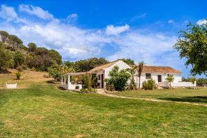 a house on a hill with a yard at Finca Santa Teresa, Casa La Higuera in Casares