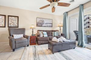 a living room with a couch and a ceiling fan at Cherry Grove Condo Steps to Beach Sleeps 8 in Myrtle Beach
