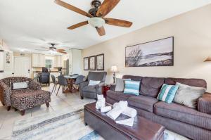 a living room with a couch and a ceiling fan at Cherry Grove Condo Steps to Beach Sleeps 8 in Myrtle Beach