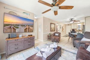 a living room with a couch and a ceiling fan at Cherry Grove Condo Steps to Beach Sleeps 8 in Myrtle Beach +42 photos