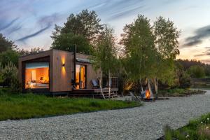 a tiny house on the side of a gravel road at РІЗНОтрав'я in Solygy
