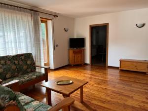 a living room with a couch and a table at Villa Clelia in Auronzo di Cadore