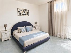 a bedroom with a large bed and a chair at Maridea - Villetta Brezza Marina in Ponza