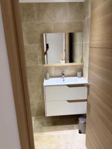 a bathroom with a sink and a mirror at Appartement 4 personnes in Sainte-Maxime +16 photos