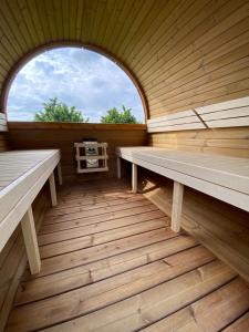 an empty sauna with two benches and a window at Agriturismo La Ruota in Montelupo Albese