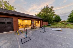 a building with a garage with a lot of equipment in front at Point Au Roche Lodge in Plattsburgh +17 photos