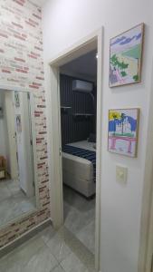 a room with a bedroom with a bed and a mirror at Dois quartos mobiliado próximo a praia in Vila Velha