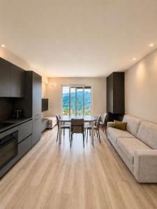 a living room with a couch and a table and chairs at Lake View Apartament 1 - Free Parking & Terrace in Cadegliano Viconago