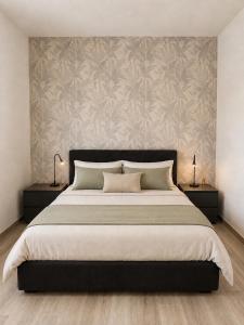 a bedroom with a large bed with two night stands at Lake View Apartament 1 - Free Parking & Terrace in Cadegliano Viconago +10 photos