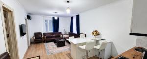 a living room with a white table and chairs at Emilia Hotel Batumi Old Town in Batumi