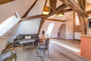 a living room with a couch and a table at Robillard 2 - Bail Partner in Auxerre