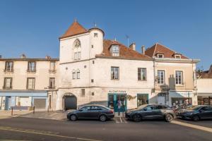 a building with cars parked in front of it at Robillard 2 - Bail Partner in Auxerre