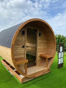 a round wooden sauna with a gambrel roof at Agriturismo La Ruota in Montelupo Albese