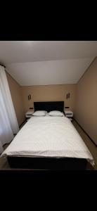 a bedroom with a large bed with two pillows at House on The Hill Bukovel in Palyanytsya +5 photos