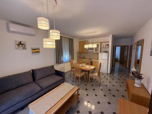 a living room with a couch and a table at Apartments Palić in Baška