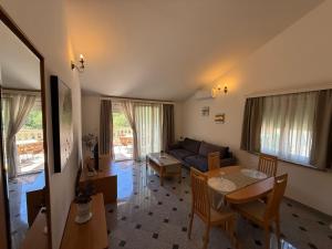 a living room with a couch and a table at Apartments Palić in Baška