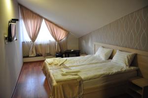 Postel nebo postele na pokoji v ubytování Hotel Imperial