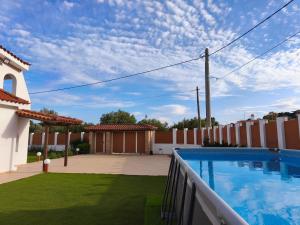 a backyard with a swimming pool and a fence at Villa Oneiron in Anavyssos