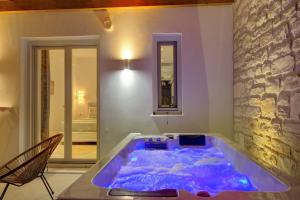 a large blue tub in a room at Sunshine Alkyoni Suite in Isterni +32 photos
