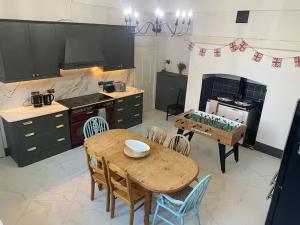 a kitchen with a wooden table and chairs and a stove at Russell Hill Manor in Peterborough
