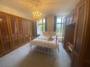 a room with a bed and a chandelier in a room at Russell Hill Manor in Peterborough