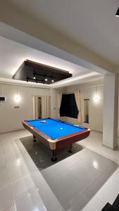 a pool table in the middle of a room at Seven Miles Hotel in Āīzawl