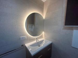 a bathroom with a sink and a mirror at Atico casa la via in Sanlúcar de Barrameda