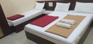 a large white bed with two pillows on it at Hotel SS Palace in Shirdi