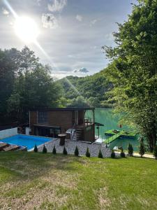 a backyard with a house and a lake at Pablo's place in Rezine