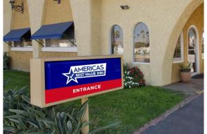a sign in front of a building at Americas Best Value Inn Irving DFW Airport South in Irving