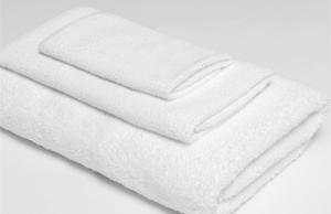 a stack of white towels on a white background at Americas Best Value Inn Irving DFW Airport South in Irving