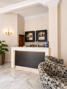 a living room with a bar and two chairs at Hotel Mazzocca in Caramanico Terme