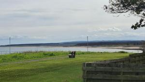 a park with a view of a body of water at Firthview Golspie in Golspie