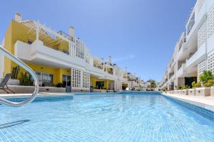 a swimming pool in the middle of a building at Olive Tree penthouse in Tavira