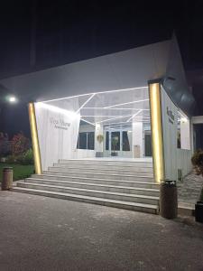 a building with stairs in front at night at Olimp sea view in Olimp