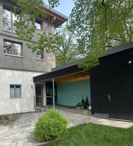 a large house with a black garage at Studio Apartment Lindennest in Waging am See