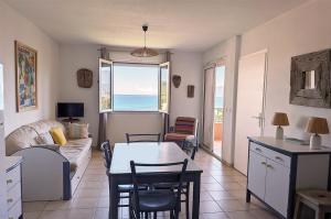 a living room with a couch and a table at Alta Suarella in Saint-Florent