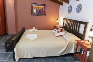 a bedroom with a bed with two pillows on it at Palazzo Collegiata Rooms & Suite in Monreale