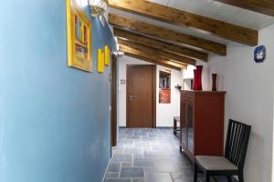 a hallway with a chair and a wooden ceiling at Palazzo Collegiata Rooms & Suite in Monreale