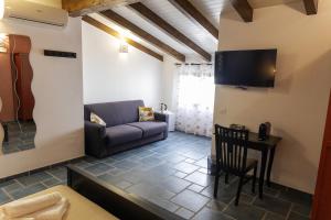 a living room with a couch and a table at Palazzo Collegiata Rooms & Suite in Monreale