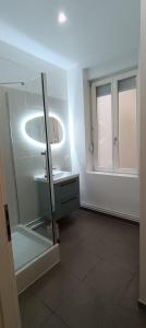 a white bathroom with a sink and a mirror at La terrasse du palais in Metz +18 photos