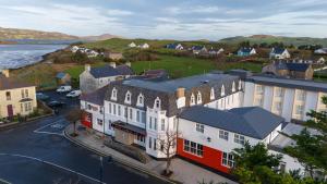 an aerial view of a town with buildings and the ocean at The Carrigart Hotel in Carrigart