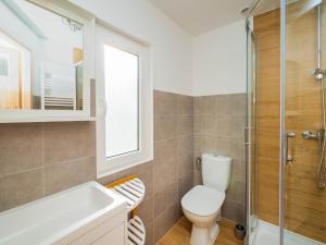 a bathroom with a toilet and a sink and a shower at Szum Fal in Rusinowo +23 photos