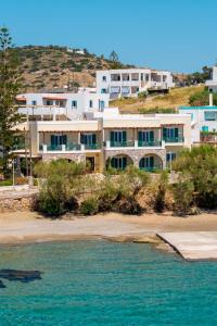 ein großes Gebäude auf einem Hügel neben einem Strand in der Unterkunft Brazzera Hotel in Finikas