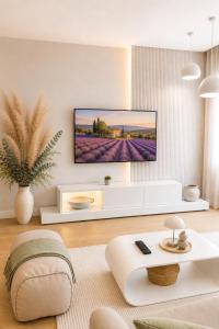 a living room with a tv on a wall at Beograd na vodi-Belgrade Waterfront in Belgrade