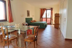 a living room with a table and chairs and a couch at Relais Cà Nova Guest House in Bogogno